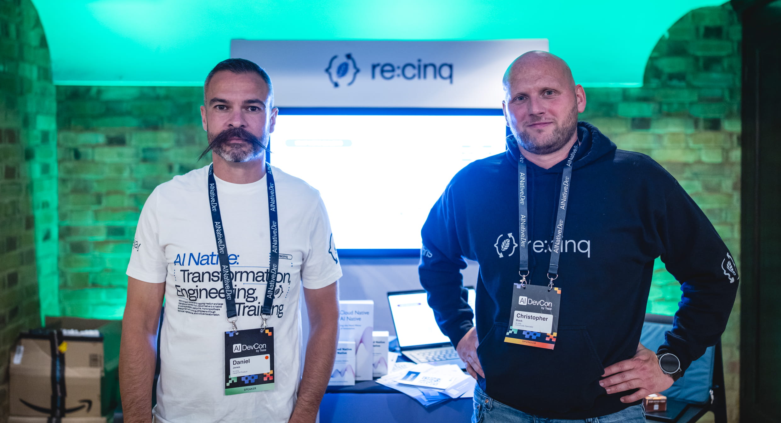 Deejay and Chris at the re:cinq booth at AI Native DevCon 2026