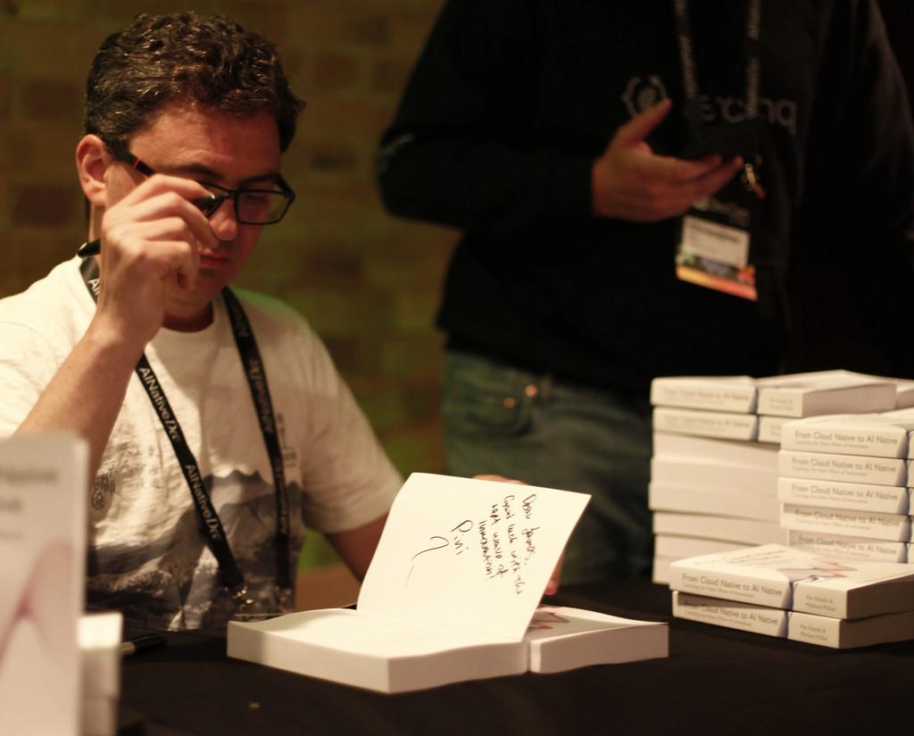 Pini Reznik signing copies of From Cloud Native to AI Native