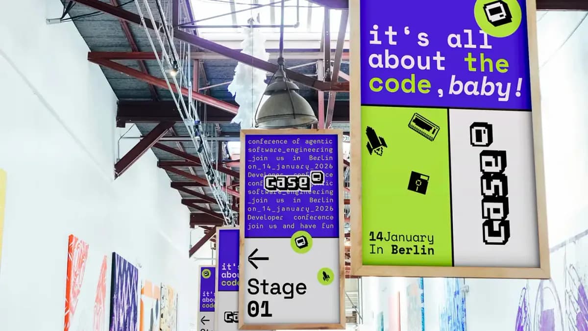 The venue hall at the CASE conference in Berlin, a stage sign and a poster reading it's all about the code, baby